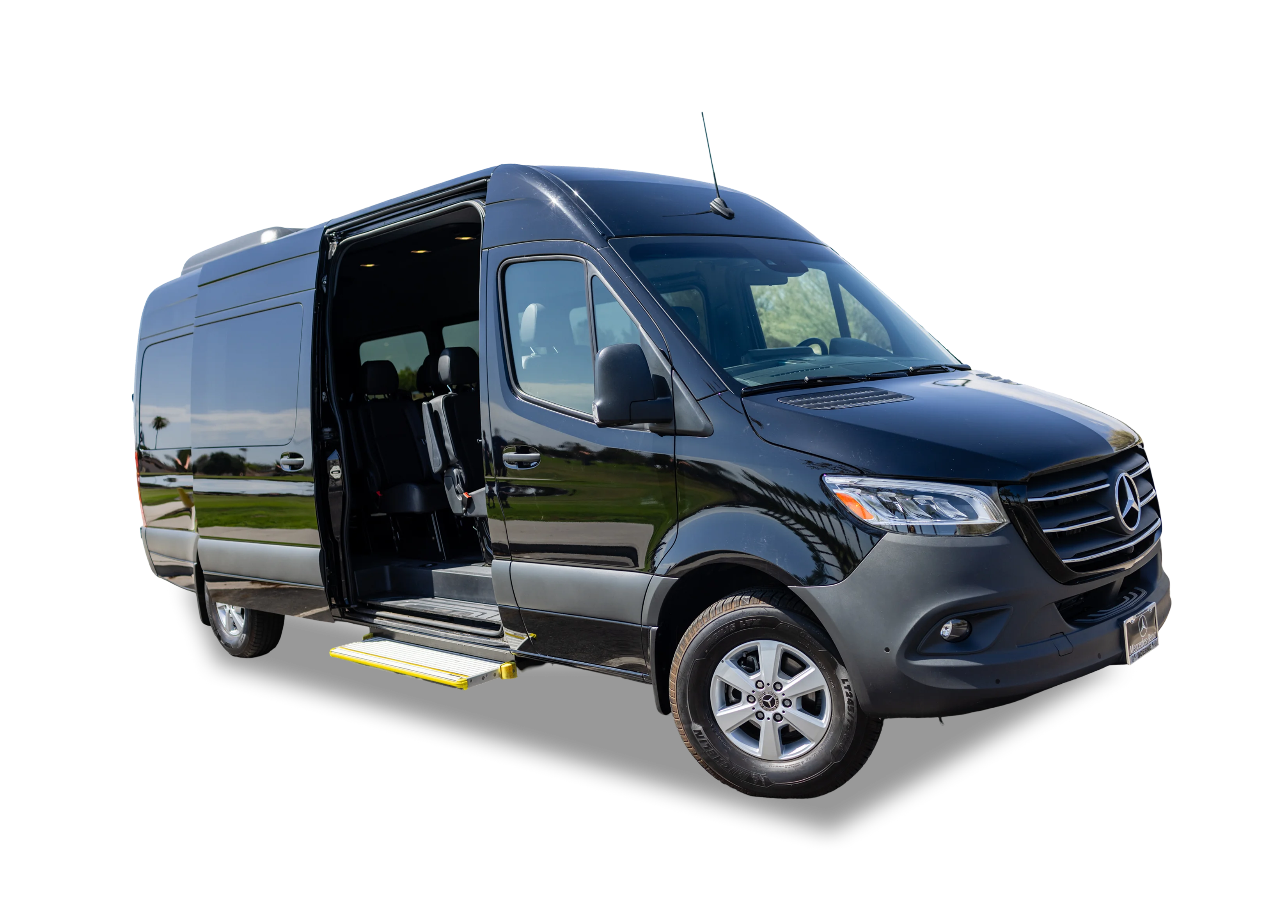 hero img (1) Black passenger van with sliding door open and a wheelchair ramp extended.