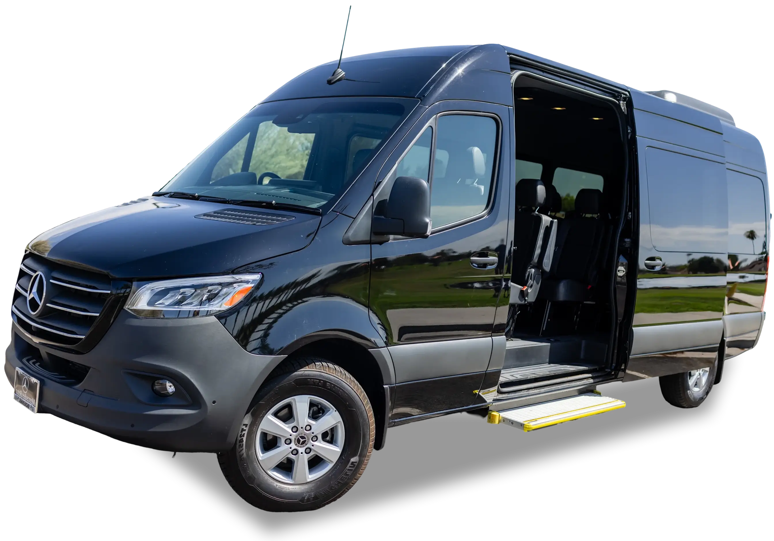 Black wheelchair-accessible van with open door and ramp.